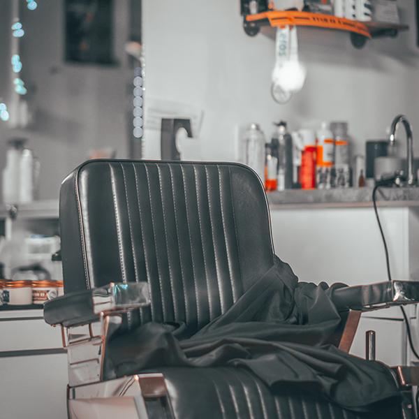 Empty black leather barber chair